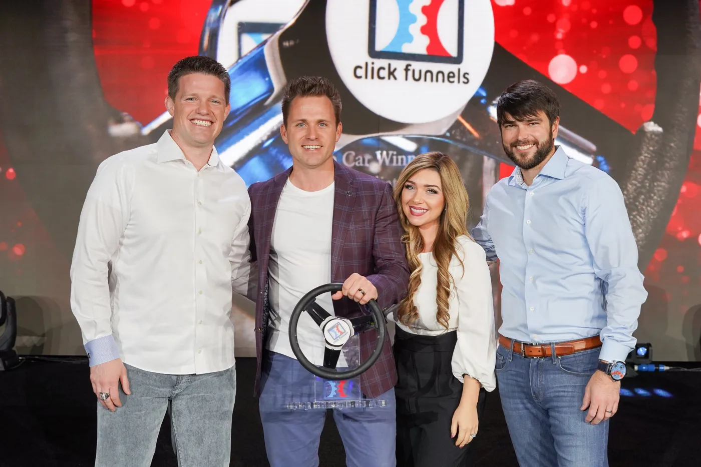 Bryan and Stephanie Dulaney with a ClickFunnels car winner award