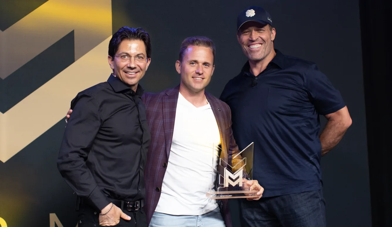 Bryan Dulaney with Dean Graziosi and Tony Robbins receiving a top affiliate award